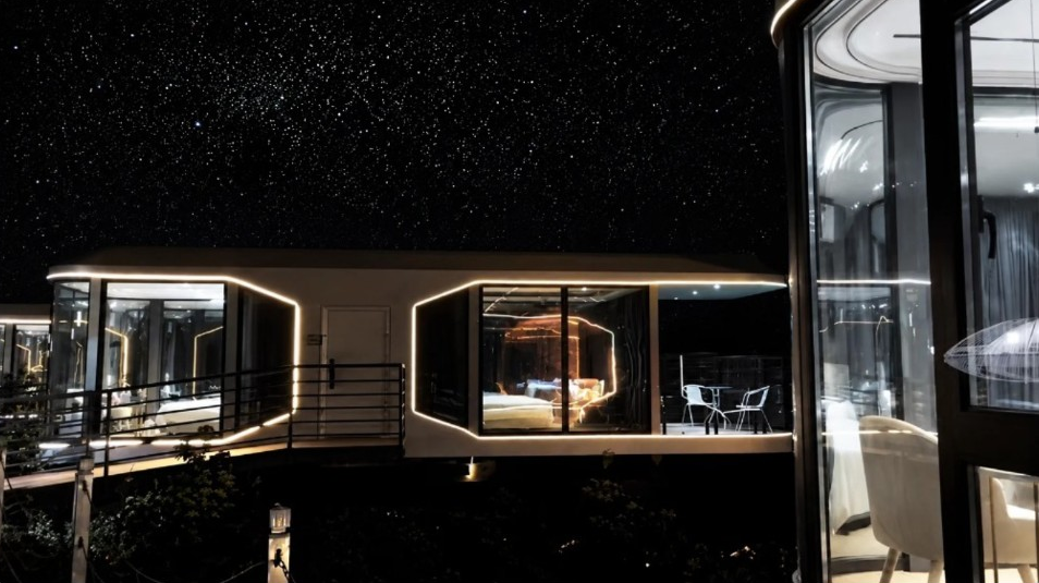Space capsule house under starry night sky