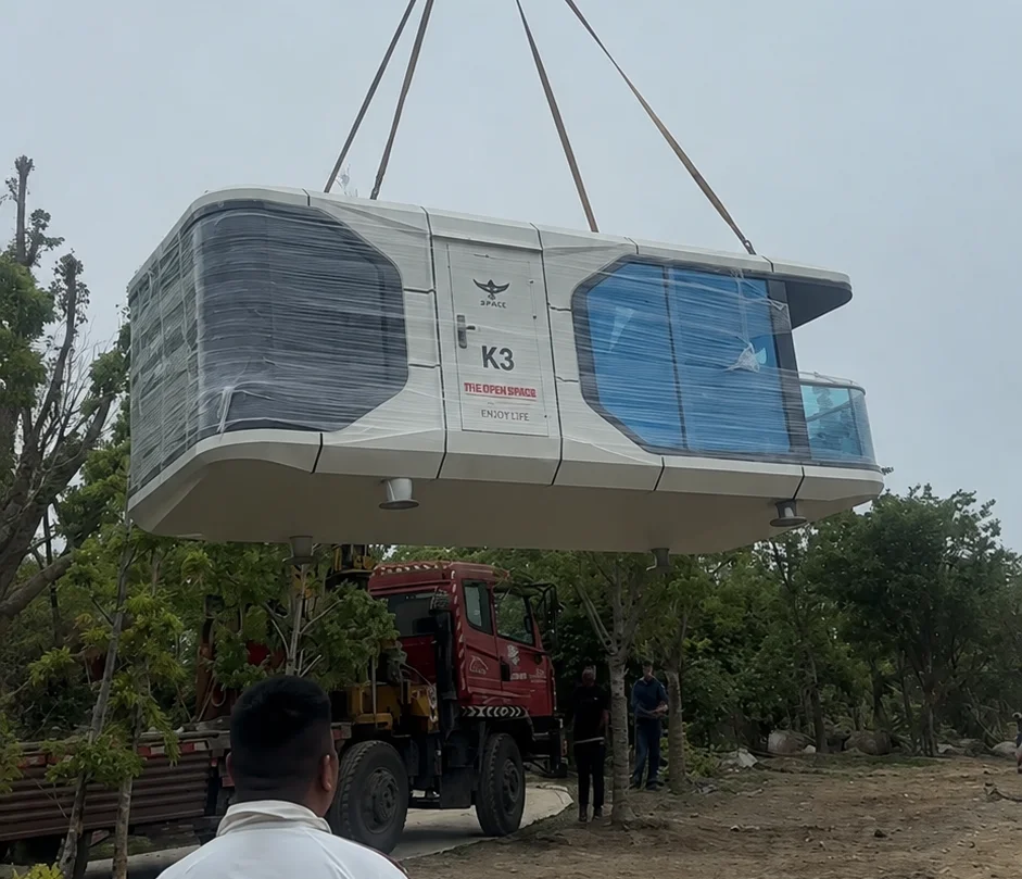 Space capsule unit being lifted by crane